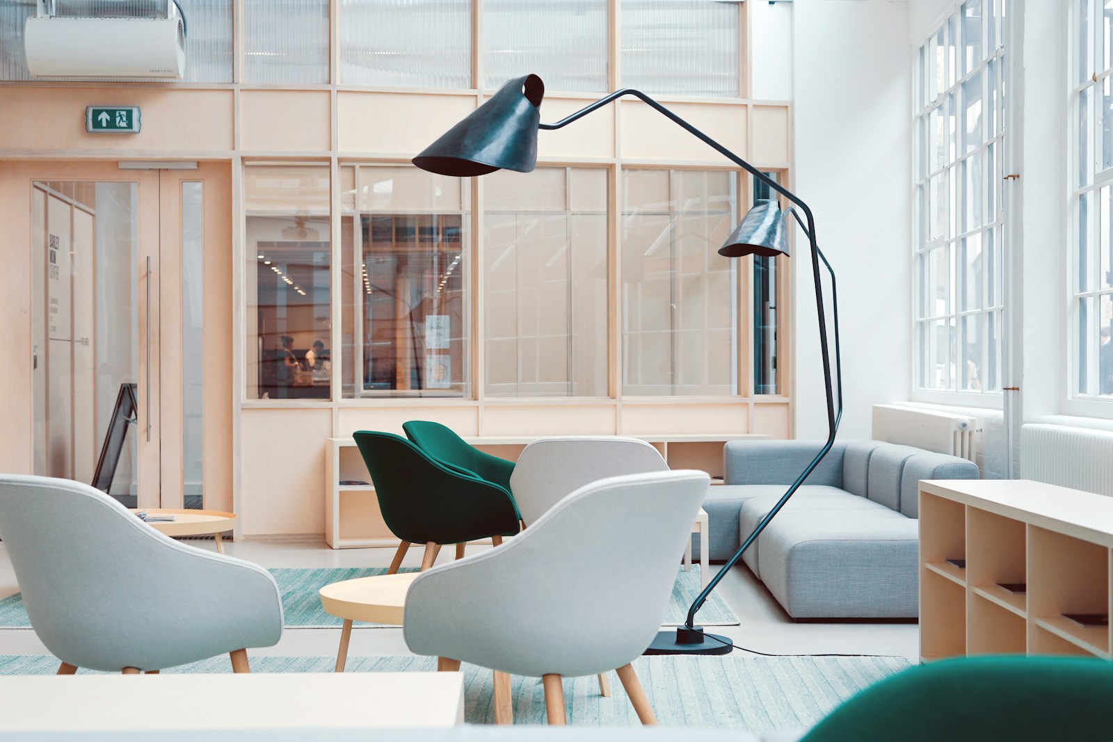 Modern co-working space with stylish chairs, lounge area, and large windows for natural light